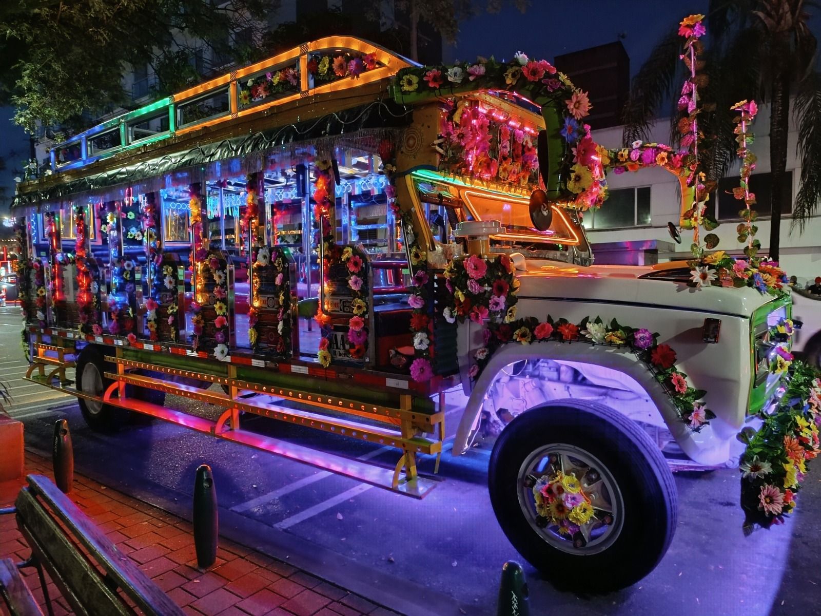 Chiva La Luminosa iluminada de noche en Medellín